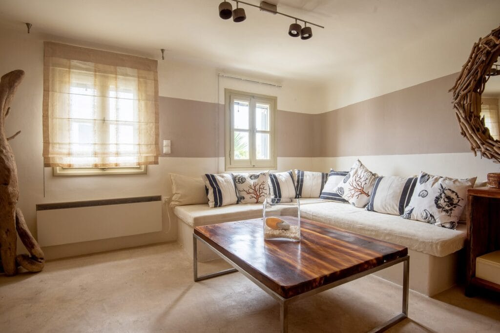 Relaxed living room seating area with patterned cushions and wooden furniture