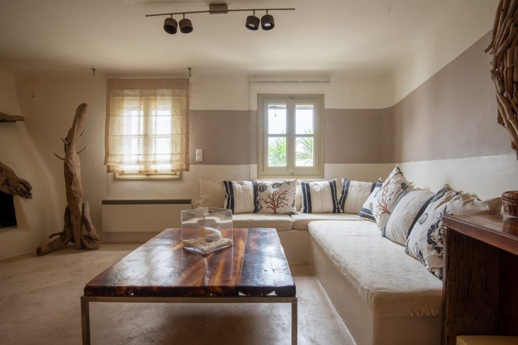 Living room with built-in sofa seating, wooden table and natural decorative details