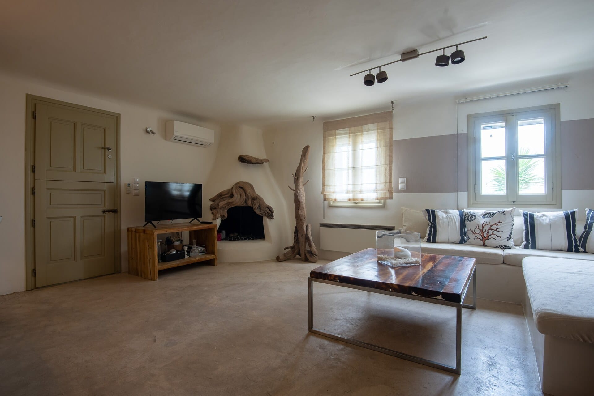 Wide view of the living room with built-in seating and a central coffee table