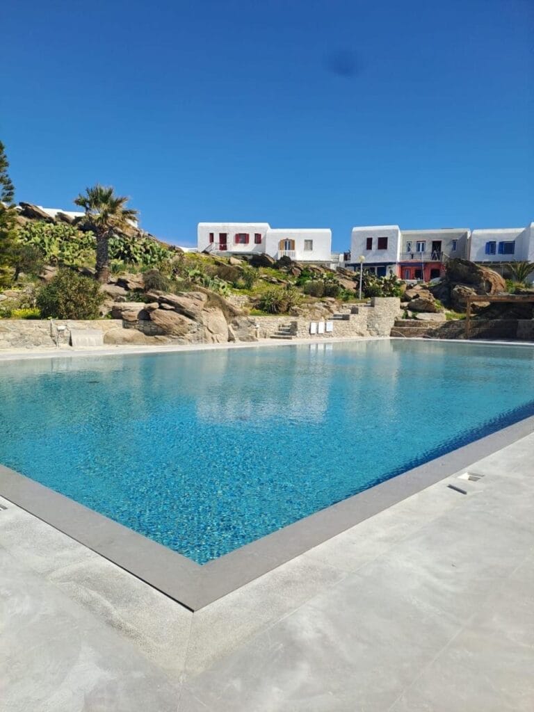 Private swimming pool beneath a clear blue sky at Mykonos Ilios House